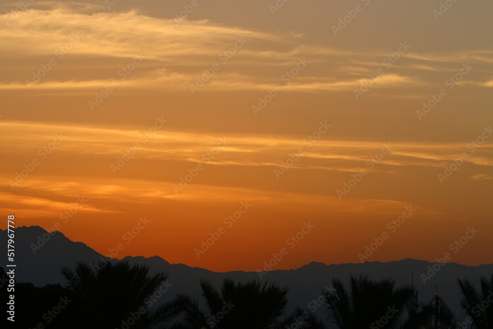 Sunrise at the Dead Sea in Israel. The sun comes out from behind the mountains in Jordan.