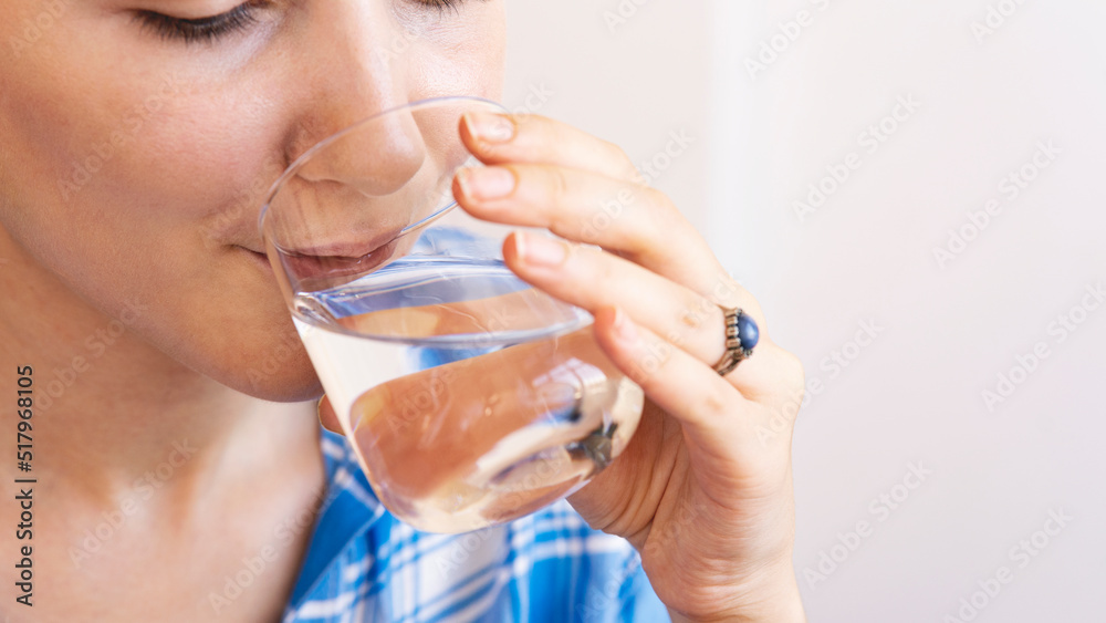 Woman drinking a fresh glass of water at home Woman drinking a fresh glass of water at home