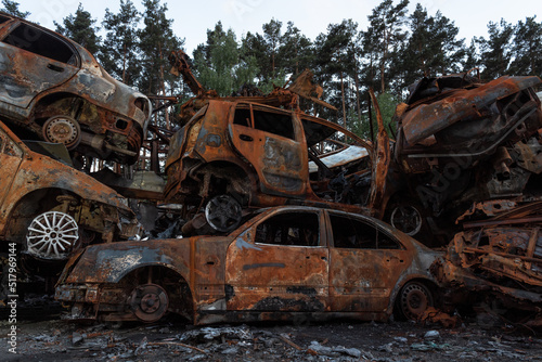 A dump of shot and burned cars as a result of the Russian invasion of Ukraine. War in Ukraine.