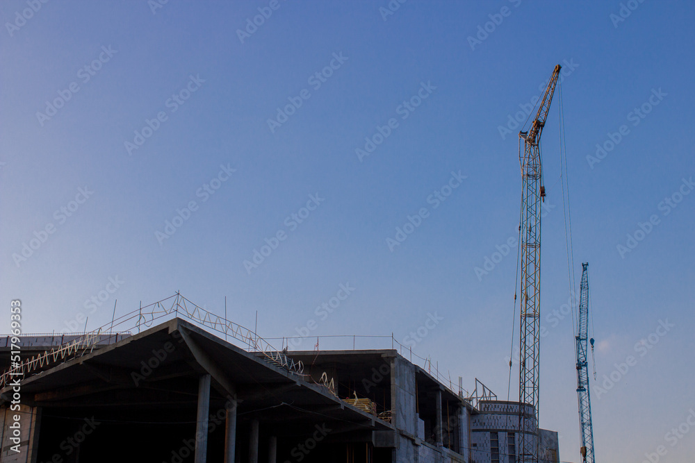 business construction cranes,building business center and entertainment center with offices, building crane on construction is not completed