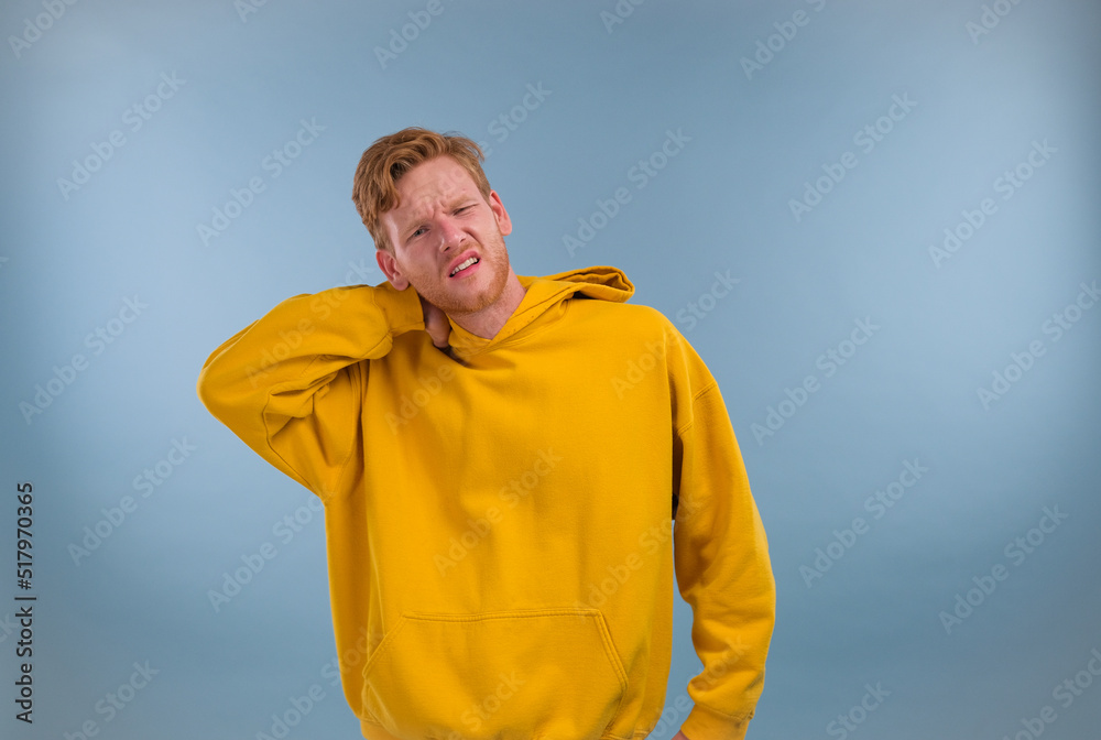 man standing over blue background suffering of neck ache injury, touching neck with hand, muscular pain man standing over blue background suffering of neck ache injury, touching neck with hand, muscular pain