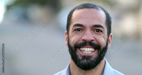 Hispanic 40s man smiling. Casual person looking at camera