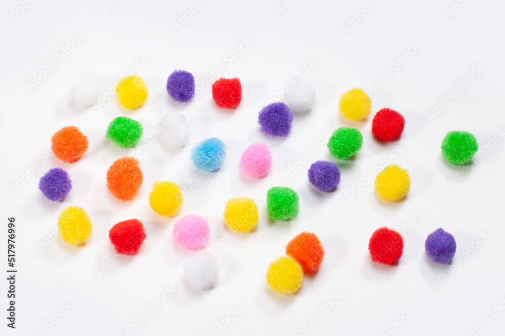 fluffy round colorful balls isolated on white surface fluffy round colorful balls isolated on white surface