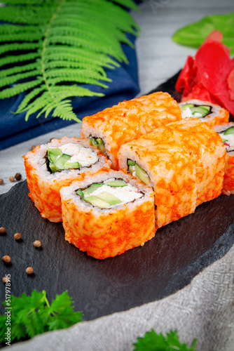 Sushi California rolls with shrimp, cream cheese, unagi and tiger prawns. Traditional Japanese cuisine