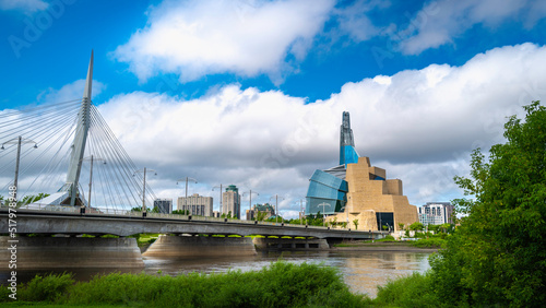 Dramatic cloudscape and landscape with the views of Esplanade Riel Footbridge and The Canadian Museum for Human Rights over the Red River in Winnipeg, Canada. photo