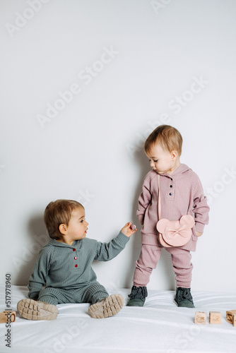 Baby fashion. Unisex clothes for babies. Two Cute baby girls or boys in cotton set photo