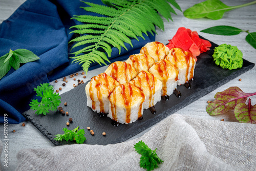Sushi rolls with cheese cap, cream cheese, iceberg lettuce and chicken. Traditional Japanese cuisine