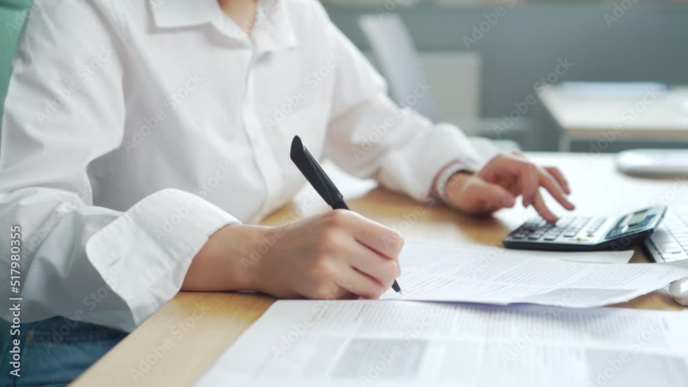 cropped hands close up young woman accountant clerk working with documents in office at workplace. calculation financial report. Uses a calculator. female Employee entrepreneur Busy doing Paperwork cropped hands close up young woman accountant clerk working with documents in office at workplace. calculation financial report. Uses a calculator. female Employee entrepreneur Busy doing Paperwork