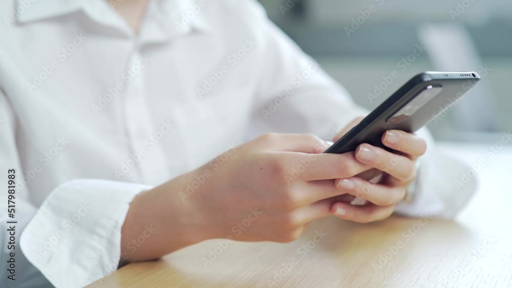 Closeup business woman typing message on mobile smart phone at home office, young girl chatting on smartphone. Close up student female hands using, browsing, chatting, texting at the computer desk Closeup business woman typing message on mobile smart phone at home office, young girl chatting on smartphone. Close up student female hands using, browsing, chatting, texting at the computer desk