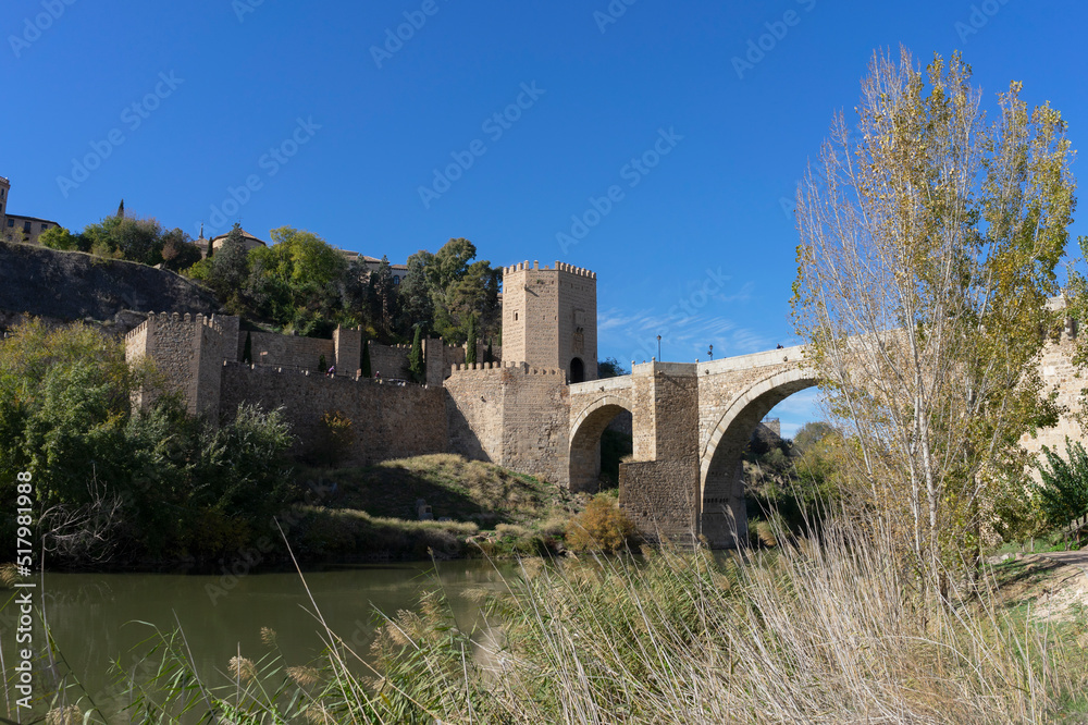 Natural landscape of the Tajo river as it passes through the medieval town of Toledo, in the photo we can see a bridge that allows you to cross the river. Spain