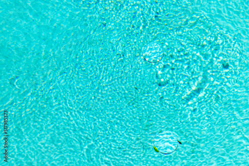 Close up of a cool blue swimming pool in summer.