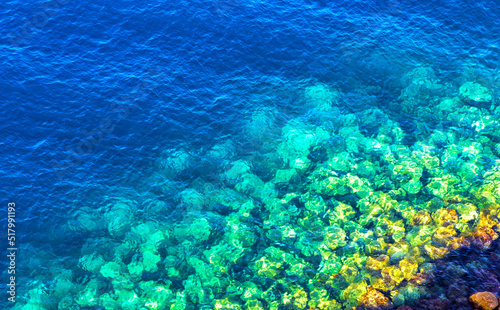 Background made of crystal clear azure and blue sea water. Mediterranean sea. View from above