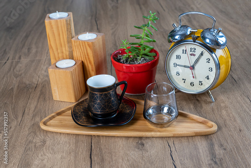 Turkish coffee concept, turkish coffee cup, glass water glass, bamboo plate, green plant with red pot, on wooden table, diagonal view, Candle Holder Cone