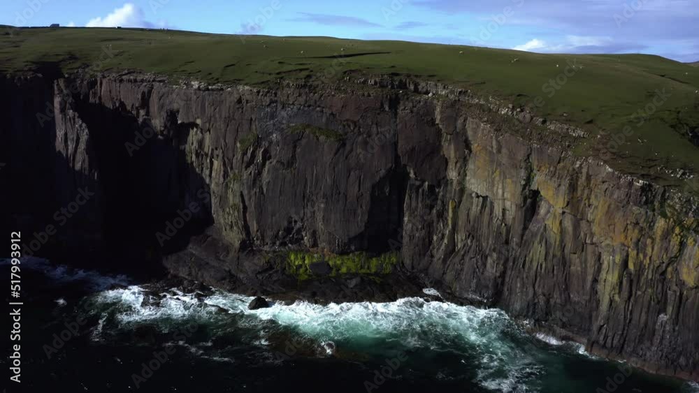 Aerial view of waves crashing into the rocks in Isle of Skye, Scotland. Aerial view of waves crashing into the rocks in Isle of Skye, Scotland.