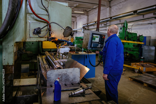 Factory engineer working on CNC drilling machine © Mulderphoto