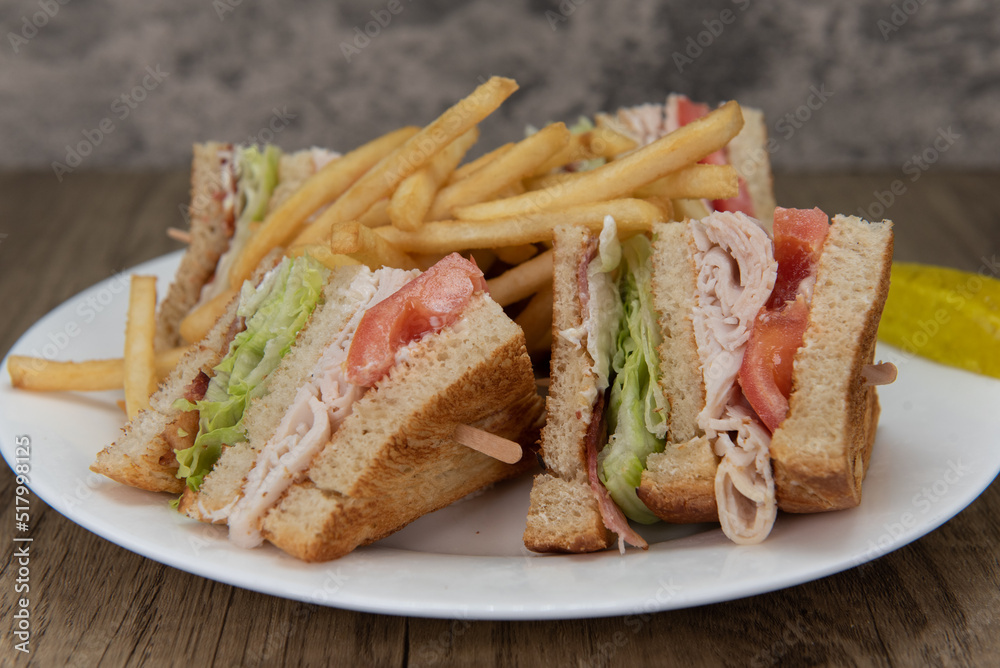 Loaded turkey club sandwich, cut into 4 wedges and covered in french fries will ensure that the belly will be full Loaded turkey club sandwich, cut into 4 wedges and covered in french fries will ensure that the belly will be full