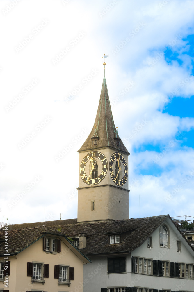 Fototapeta premium Selective focus of St. Peter Church Zurich clock tower during day time with sunflare.