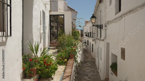 Narrow street and whitewashed houses in hilltop town of Frigiliana, Frigiliana, Malaga photo