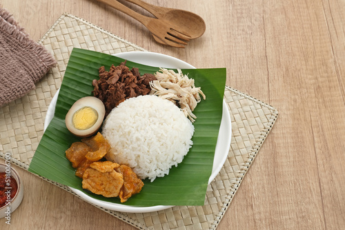 Gudeg, a typical food from Yogyakarta, Indonesia, made from young jackfruit cooked with coconut milk. Served with spicy stew of cattle skin crackers, brown eggs, shredded chicken and sambal.
 photo