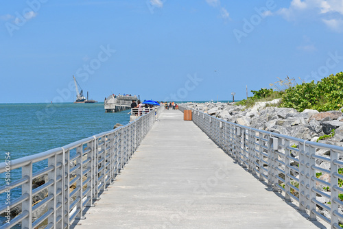 Concrete walking and fishing pier at Jetty State Park in the port at Cape Canaveral near Cocoa Beach, Florida.  © Ryan Tishken