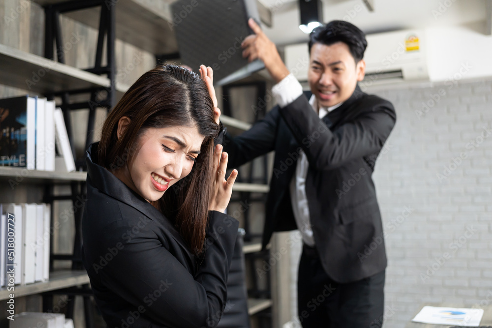 Emotional colleagues fighting in office. Workplace conflict. Angry boss. Man as a boss in the office is violent against a woman as an employee Emotional colleagues fighting in office. Workplace conflict. Angry boss. Man as a boss in the office is violent against a woman as an employee