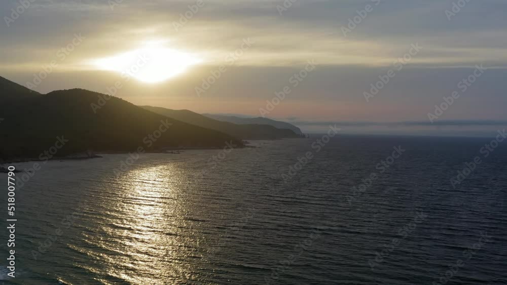 Sea stack vertically sticking out of the water at dawn. Drone view, panoramic view. Cape Laplace, East Sea
