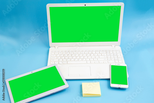 Blue background, various electronic tablets, laptops, smartphones