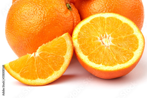 whole and cut fresh orange fruit and slices isolated on white background  Blood oranges whole and sliced on white surface. Ripe half of pink orange citrus fruit  front view copy space isolated macro.