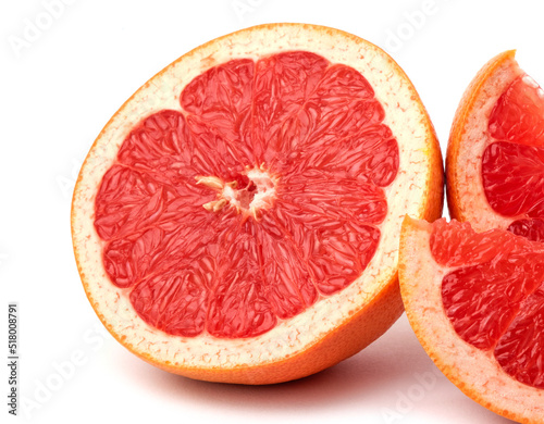 whole and cut fresh grapefruit and slices isolated on white background, Blood oranges whole and sliced on white surface. Ripe half of pink grapefruit citrus fruit, front view copy space isolated macro