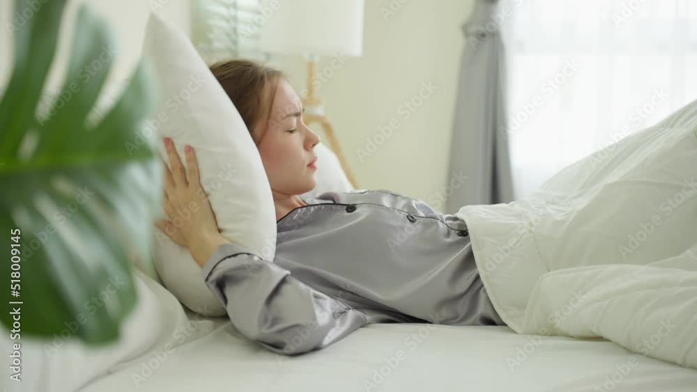 Caucasian beautiful frustrated girl in pajamas sleep on bed in morning