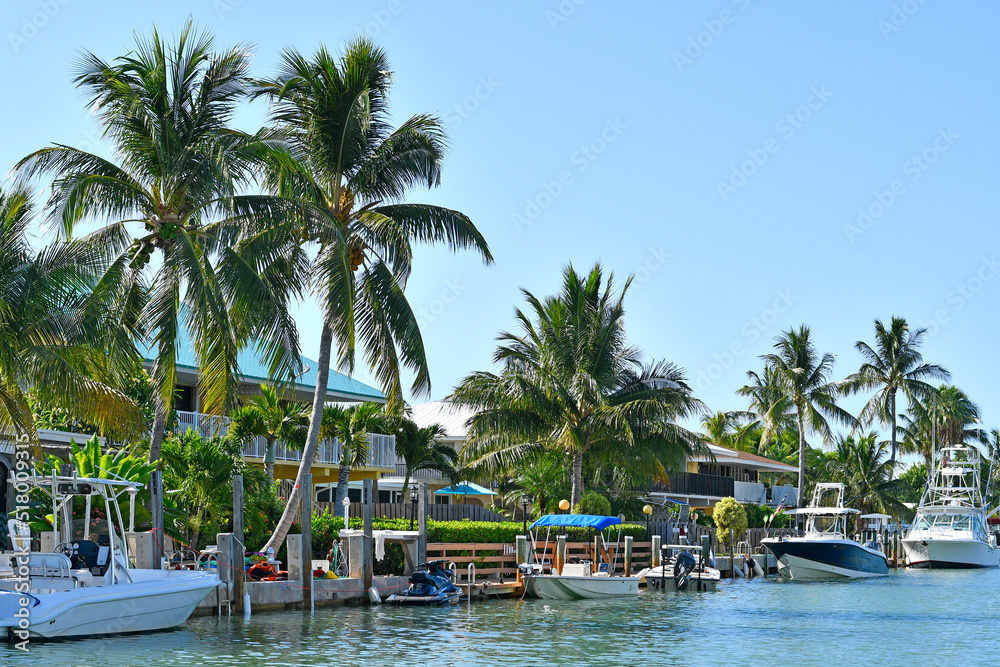 Boats parked along waterfront behind homes in Marathon Key in the Florida Keys