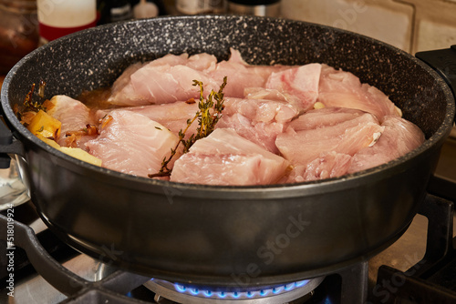 Fish stewed with carrots, mushrooms and potatoes is fried in pan on gas stove to make palmid fish stew with vegetables. Step by step recipe photo
