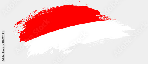 National flag of Indonesia with curve stain brush stroke effect on white background
