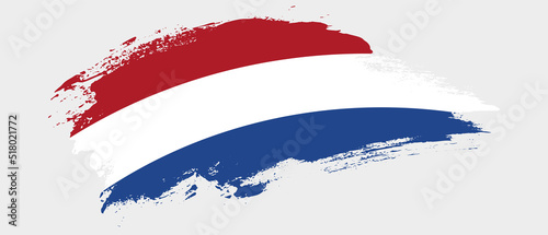 National flag of Netherlands with curve stain brush stroke effect on white background photo