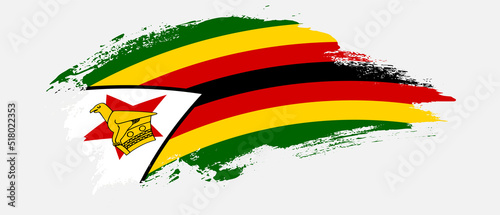 National flag of Zimbabwe with curve stain brush stroke effect on white background
