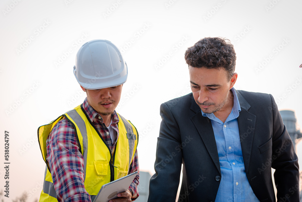 Businessman and engineer meeting and discuss project in working site, Teamwork project concept. Businessman and engineer meeting and discuss project in working site, Teamwork project concept.