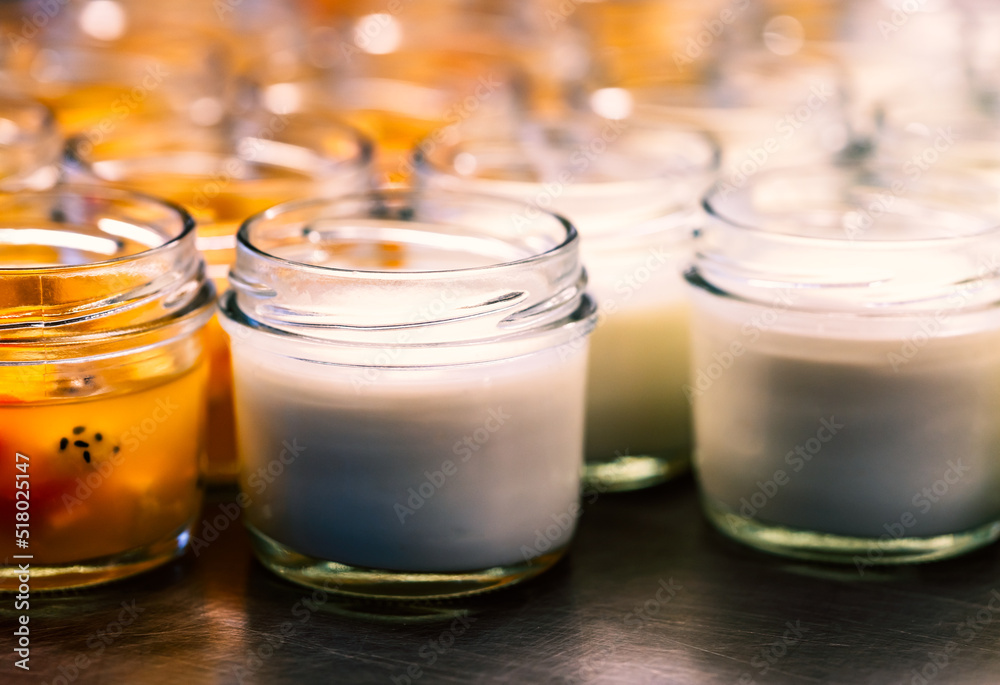 Small bottle glass of Yogurt and fruit salad on stainless steel shelf with, close-up homemade yogurt and fruit salad with warm light. Small bottle glass of Yogurt and fruit salad on stainless steel shelf with, close-up homemade yogurt and fruit salad with warm light.