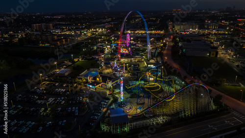 Amazing aerial view of an amusement park in Orlando Florida at night with the big roller coaster photo