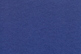 Texture of navy blue and ultramarine colors paper background, macro. Structure of dense craft cobalt cardboard.