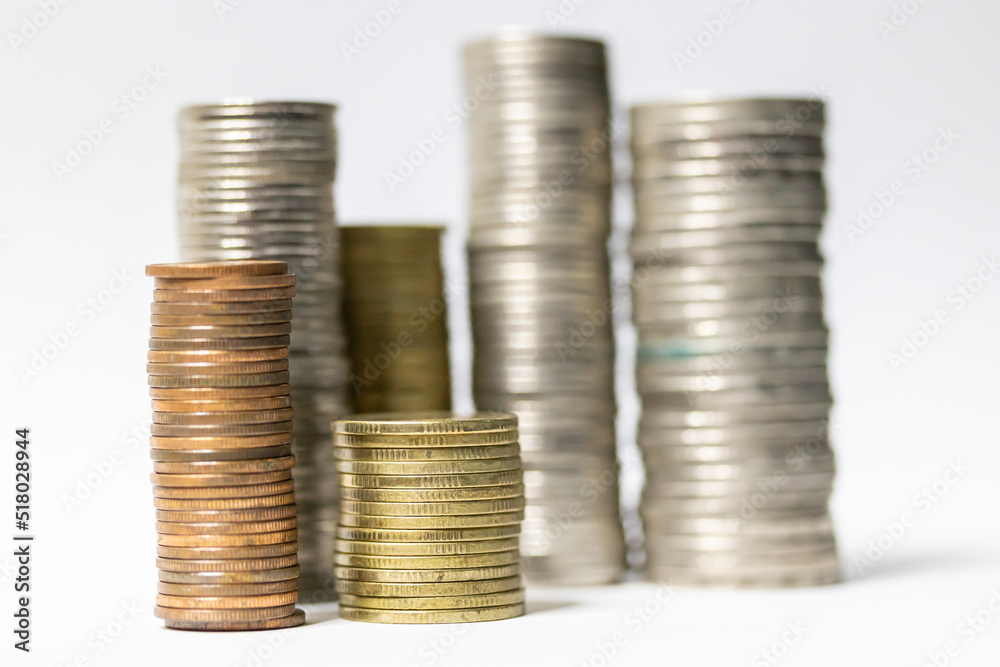 Pile of coins in white background close-up arranged in a row Pile of coins in white background close-up arranged in a row