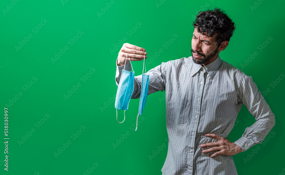 Man deciding which surgical mask to wear, Person deciding to wear a surgical mask in an isolated context, People deciding which mask to wear Man deciding which surgical mask to wear, Person deciding to wear a surgical mask in an isolated context, People deciding which mask to wear