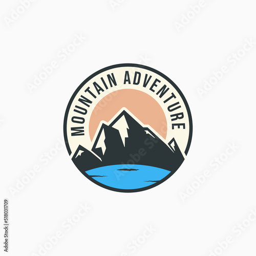 Summer mountain lake logo design. Mountain travel badge concept. Simple mountain outdoor activity emblem concept.