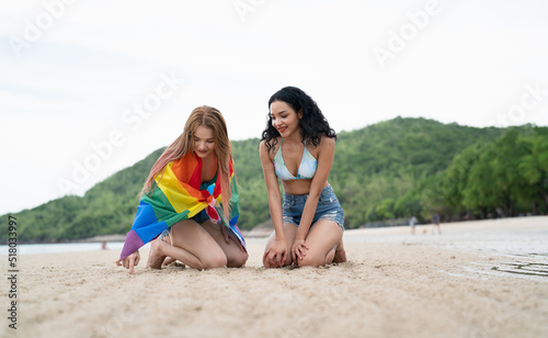 Holiday concept LGBT of two girls walking on the beach