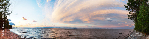 Baikal lake in summer. Unusual stratus clouds over the Small Sea Strait in the early morning before dawn. Beautiful summer landscape. Natural background. Panorama, banner