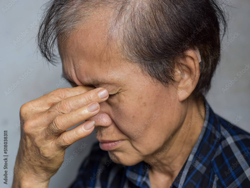 Asian man massaging his eye. Concept of eye pain, strain or itchy eyelid. Asian man massaging his eye. Concept of eye pain, strain or itchy eyelid.
