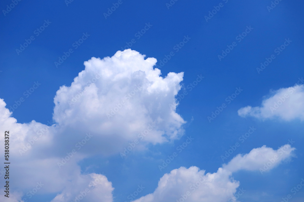 Fluffy Cumulus Clouds Floating on Vivid Blue Sunny Sky Fluffy Cumulus Clouds Floating on Vivid Blue Sunny Sky
