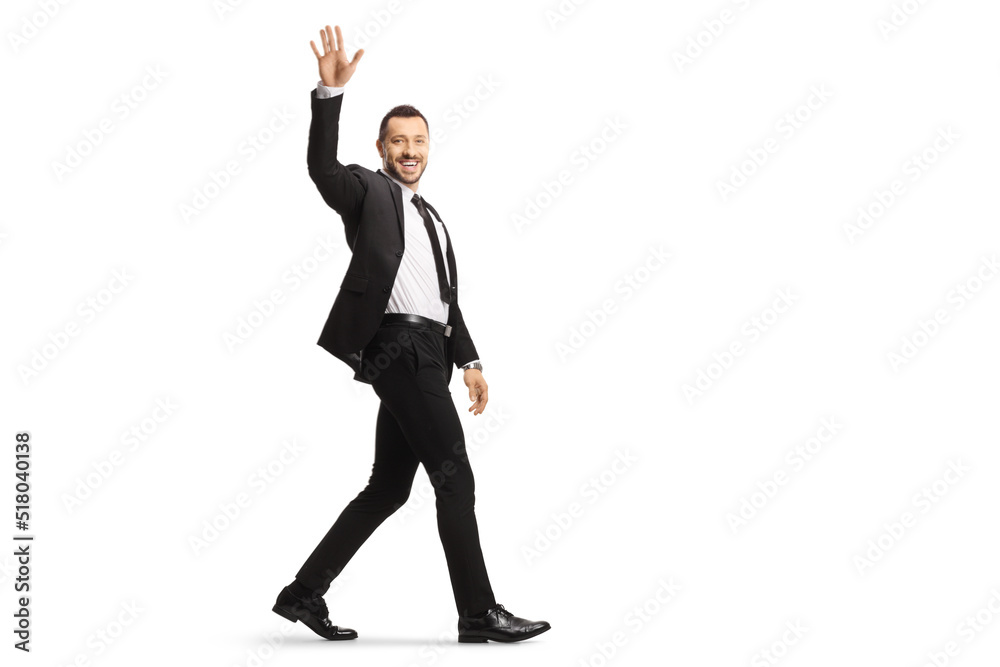 Full length shot of a young businessman walking and waving