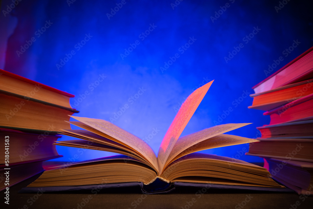 Naklejka premium Wisdom and education concept.Book on the table, love reading. Retro neon light 90s