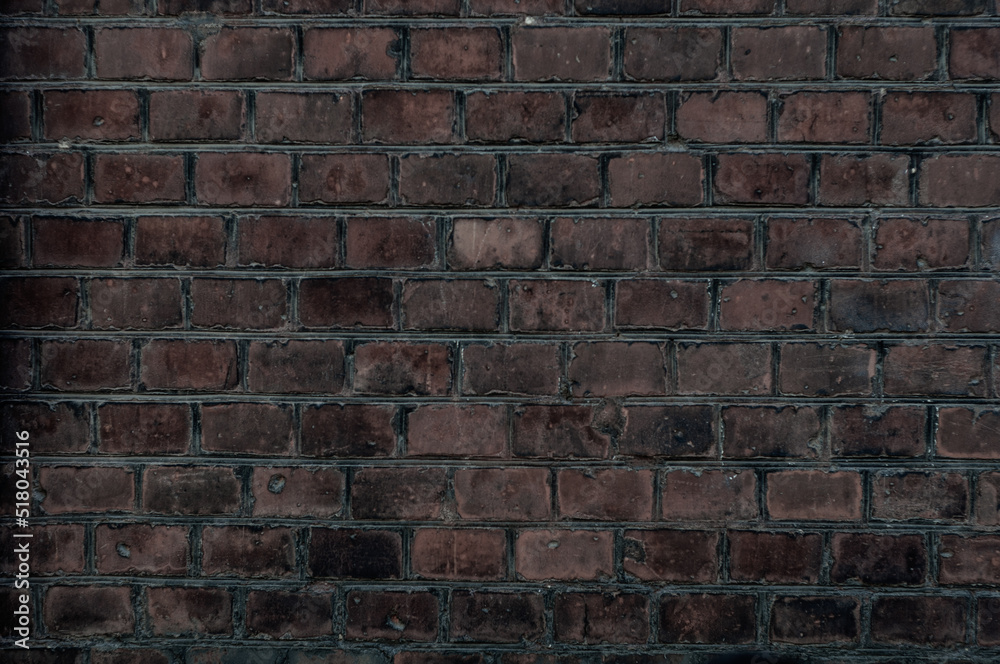 Fototapeta premium Old brick wall with red bricks close up.