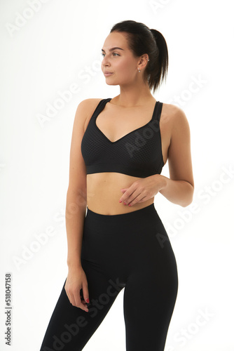 Perfect slim tanned young female body in sportswear. Concept perfect body, no fat, motivation, healthy lifestyle, fitness routine. Isolated white background. © MASTER111111